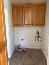 Laundry room featuring hookup for a washing machine, hookup for an electric dryer, and cabinet space