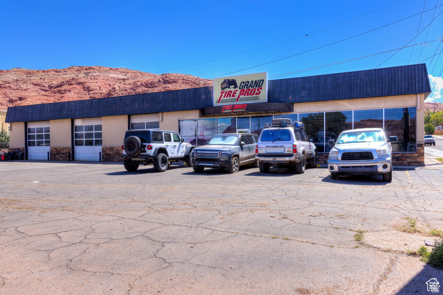 View of commercial property with uncovered parking