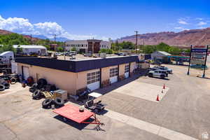 View of building exterior featuring a mountain view and a detached garage