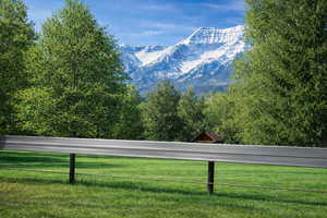 Photo standing on the property looking south over the fence from the front of the property