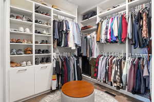 Walk in closet with light wood-type flooring