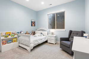 Bedroom with light carpet and baseboards