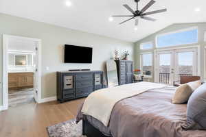 Bedroom featuring french doors, access to outside, hardwood / wood-style floors, recessed lighting, and lofted ceiling