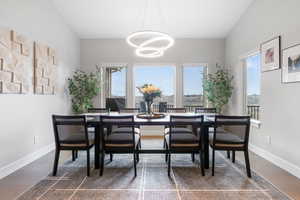 Dining area featuring wood finished floors and a chandelier