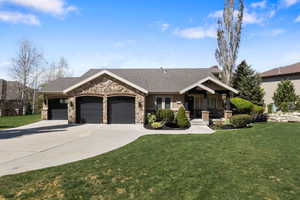Craftsman house featuring a front lawn, a garage, covered porch, driveway, and a shingled roof