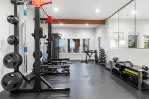 Exercise room with beamed ceiling and recessed lighting