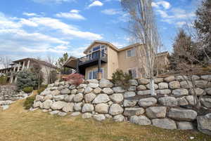 Back of property featuring stucco siding and a balcony