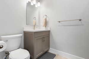 Half bathroom with vanity and toilet