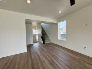 Unfurnished living room featuring dark wood finished floors and recessed lighting