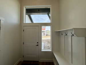 Mudroom with dark wood-style floors and baseboards