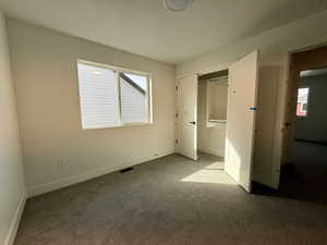 Unfurnished bedroom with carpet floors and a closet