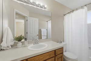 Bathroom with vanity and shower / tub combo