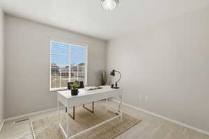 Office area with light colored carpet and baseboards