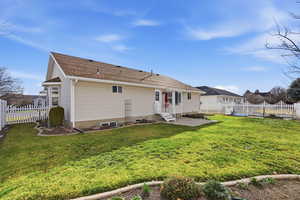 Rear view of house featuring a patio area, a fenced backyard, and entry steps