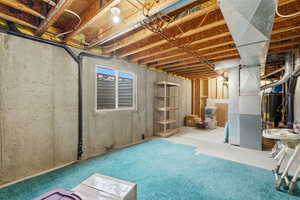 Below grade area featuring heating unit and gas water heater