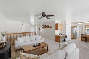 Living room with light carpet and ceiling fan