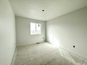 Spare room featuring baseboards