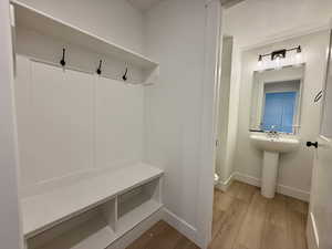 Mudroom featuring light wood-type flooring and baseboards
