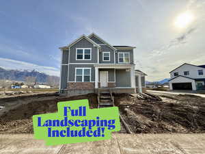 View of front of property with a mountain view and a porch