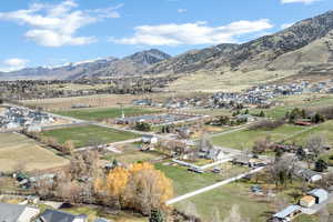 View of rural area with a mountainous background and nearby suburban area