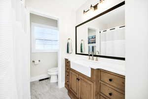 Full bath with vanity, a shower with shower curtain, and light marble finish flooring