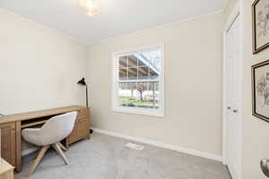 Office area with light colored carpet and crown molding