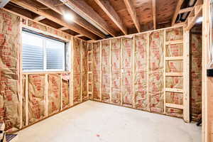 Miscellaneous room with unfinished concrete floors