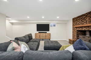 Living area with recessed lighting and carpet floors