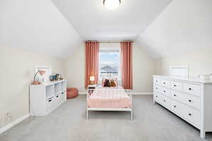 Bedroom with baseboards and light colored carpet
