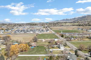 Aerial view of sparsely populated area with a mountain backdrop and nearby suburban area