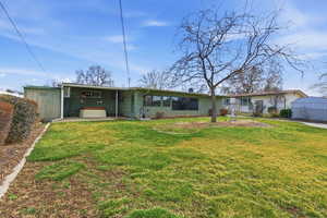 Back of property with a yard and a patio area