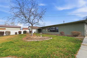 Ranch-style home with a front lawn and an attached garage