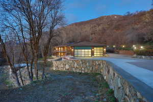 View of front of house featuring concrete driveway, a garage, and a mountain view