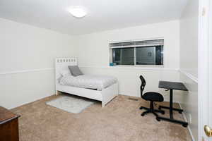 Bedroom with carpet flooring and baseboards