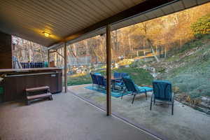 View of patio / terrace with a trampoline and a hot tub