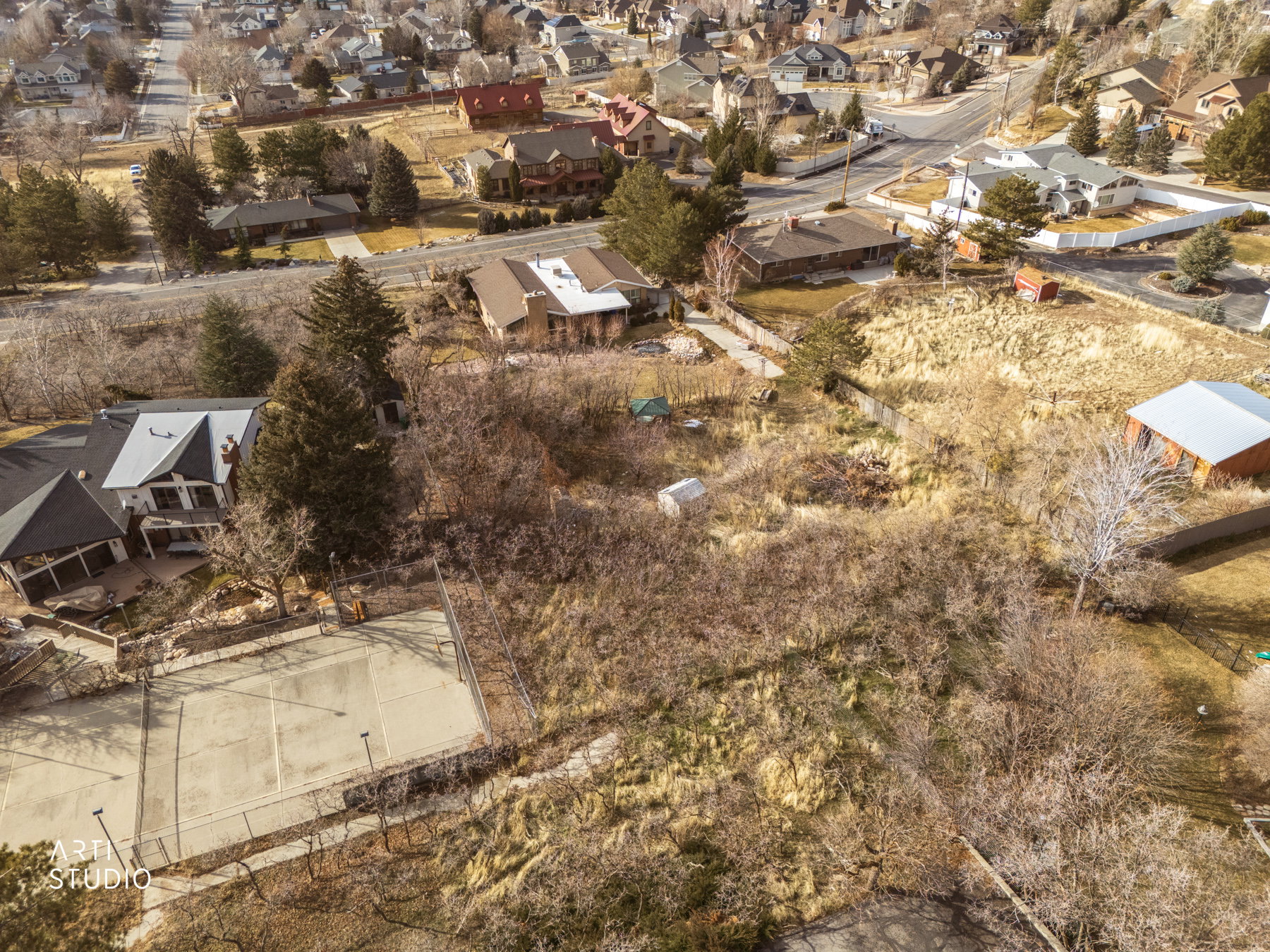 Aerial view of property and surrounding area featuring nearby suburban area