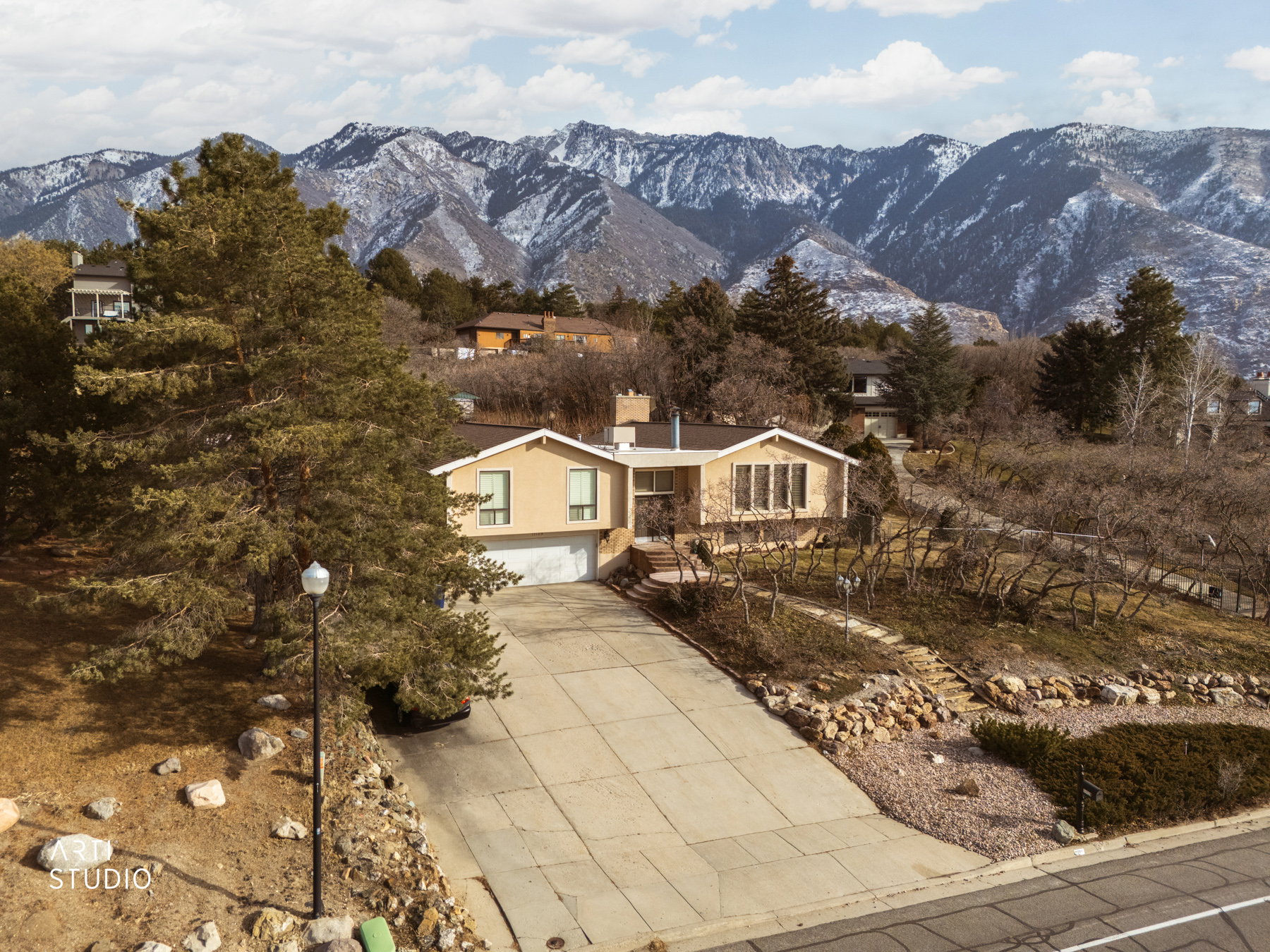 View of front of house with a garage, a mountain view, and concrete driveway