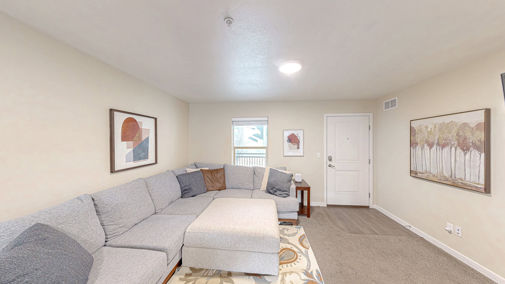 Living room featuring baseboards and light carpet