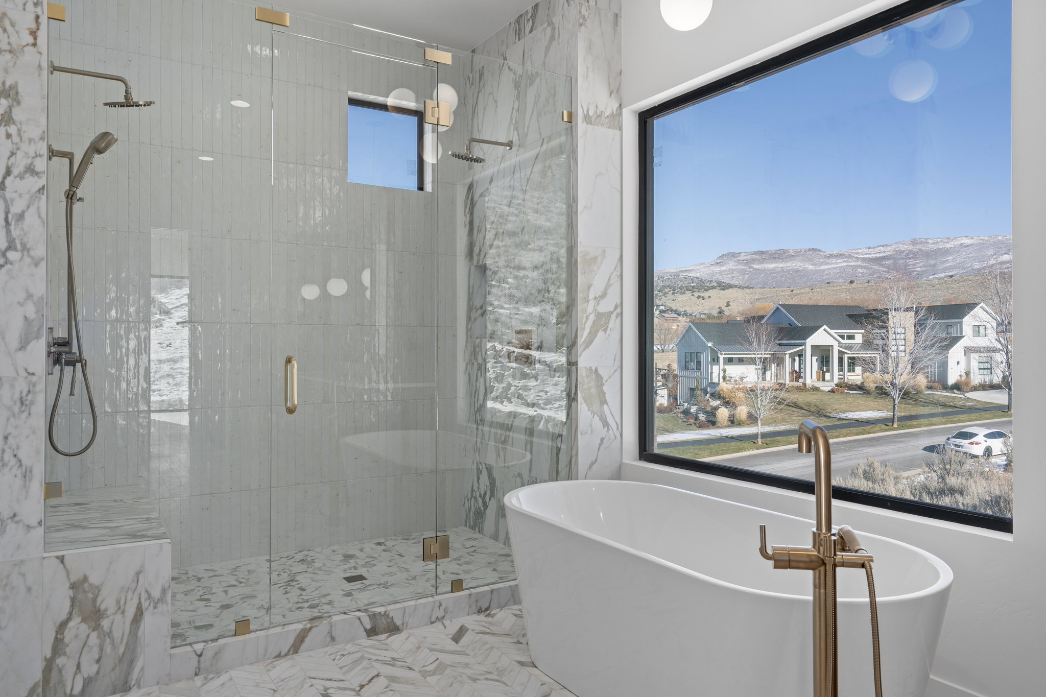 Primary Bathroom with a freestanding bath, a shower stall, and a mountain view