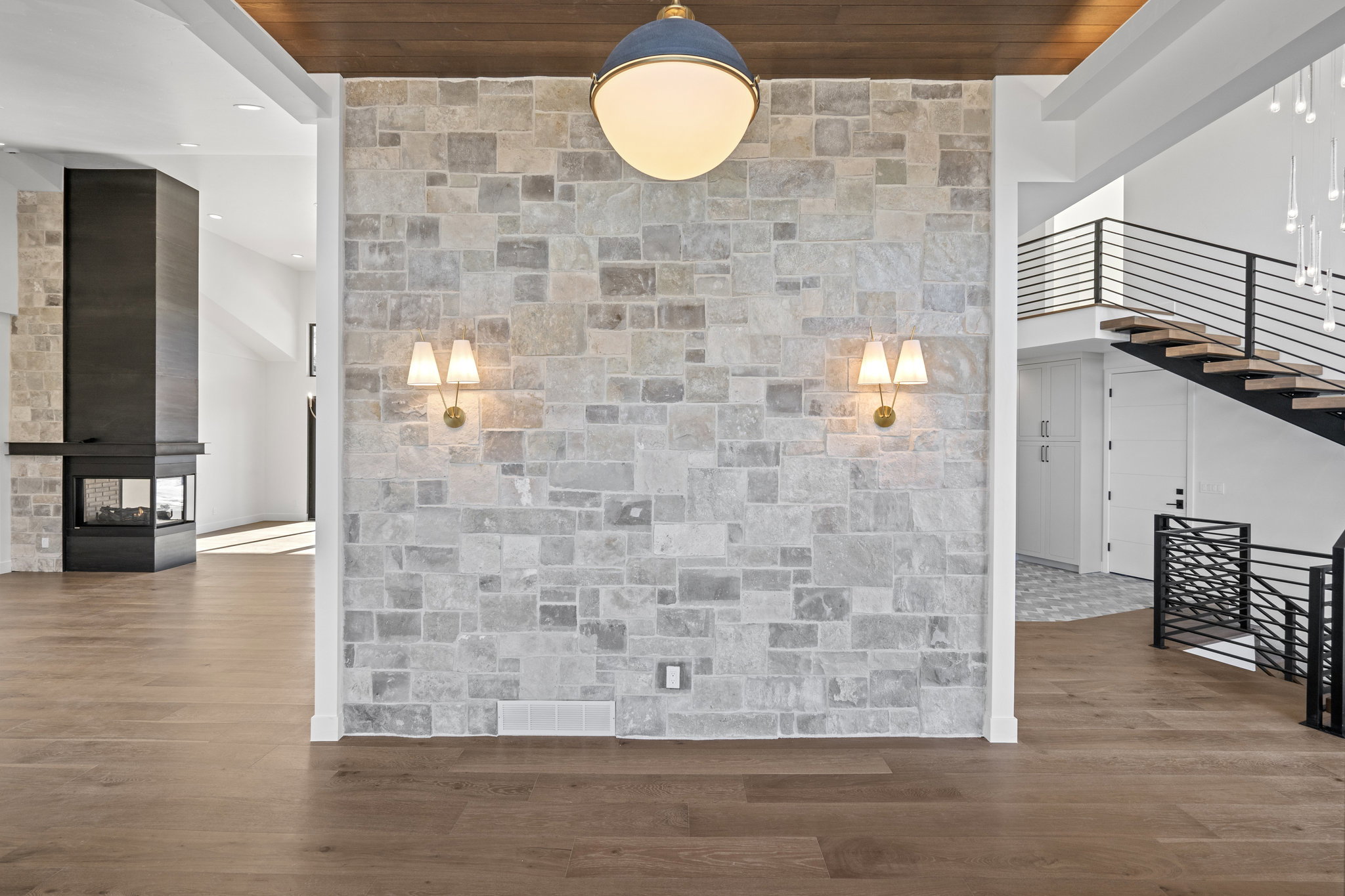 Front entry with wood finished floors, a high ceiling, and recessed lighting