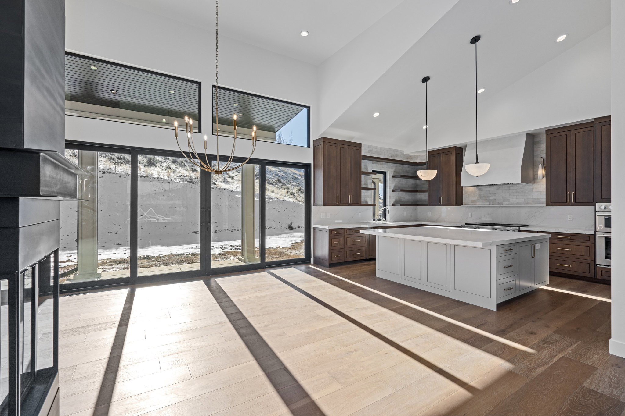 Dual tone kitchen with dual tone cabinetry, a kitchen island, backsplash, dark wood finished floors, and open shelves