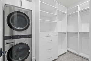 ADU closet with Laundry area with stacked washing machine and dryer