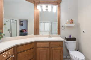 Ensuite bathroom featuring a shower stall and vanity