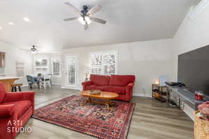 Living room featuring light wood-type flooring, a ceiling fan, and recessed lighting