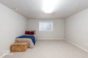 Unfurnished bedroom with carpet floors and a textured ceiling