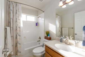 Bathroom with vanity and shower / bathtub combination with curtain