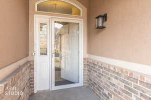 Doorway to property with stucco siding