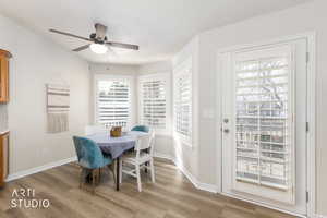 Dining space with light wood finished floors and ceiling fan