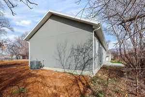 View of home's exterior featuring a central AC unit and stucco siding