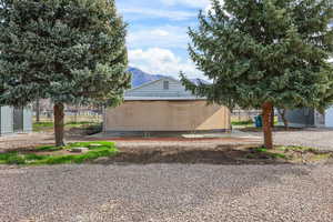 View of side of property featuring a mountain view and an outbuilding